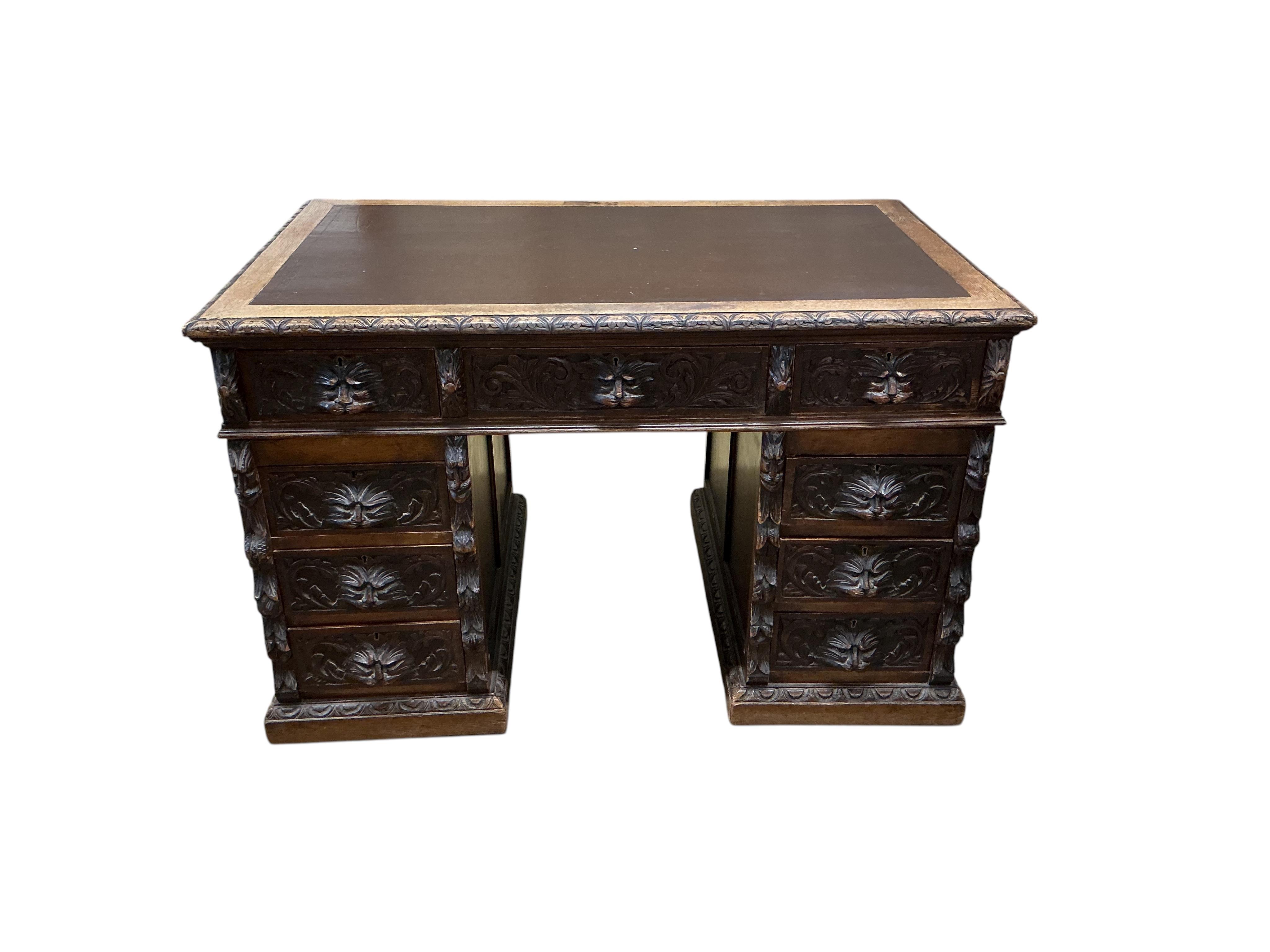 A late Victorian Flemish carved oak pedestal partners desk, width 121cm, depth 75cm, height 76cm